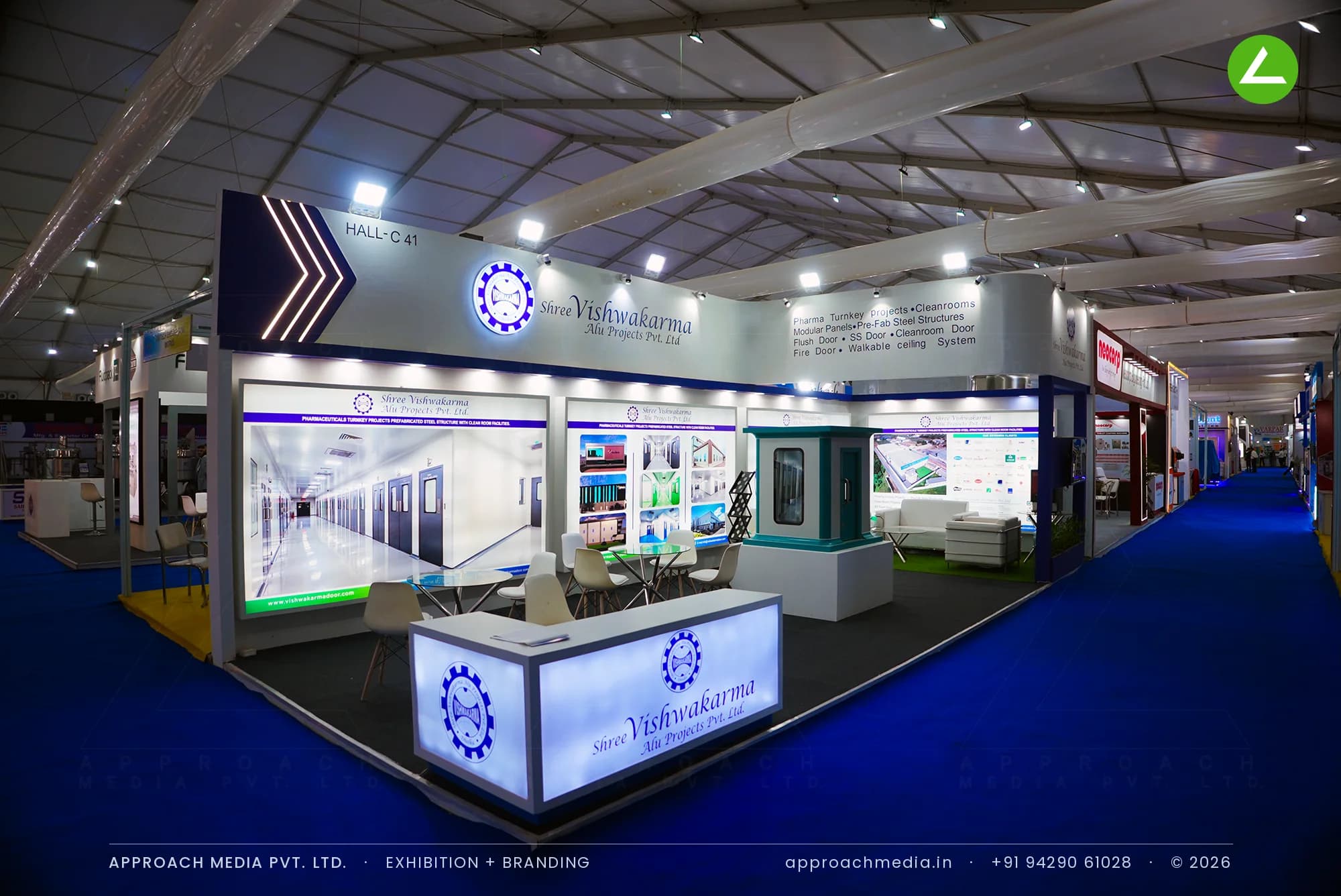 Shree Vishwakarma exhibition stall design at Pharmatech Expo Chandigarh with a lit counter and navy-framed graphic wall