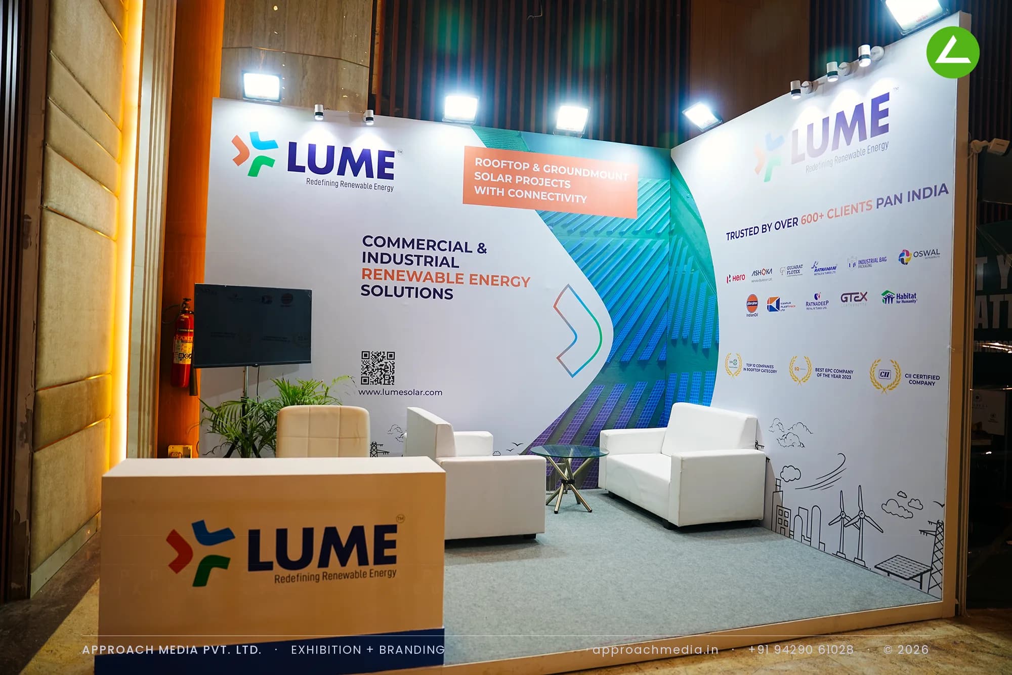 Printed teal brand wall and sofa lounge at the LUME exhibition stall design at Vyapar Bazaar Ahmedabad