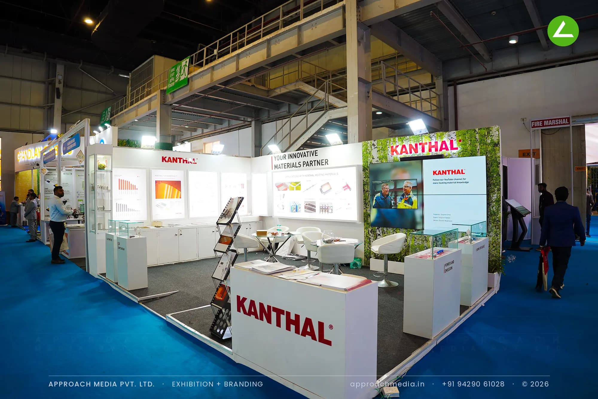 White Kanthal exhibition stall design at ELECRAMA Greater Noida with backlit panels and segment-labelled plinths