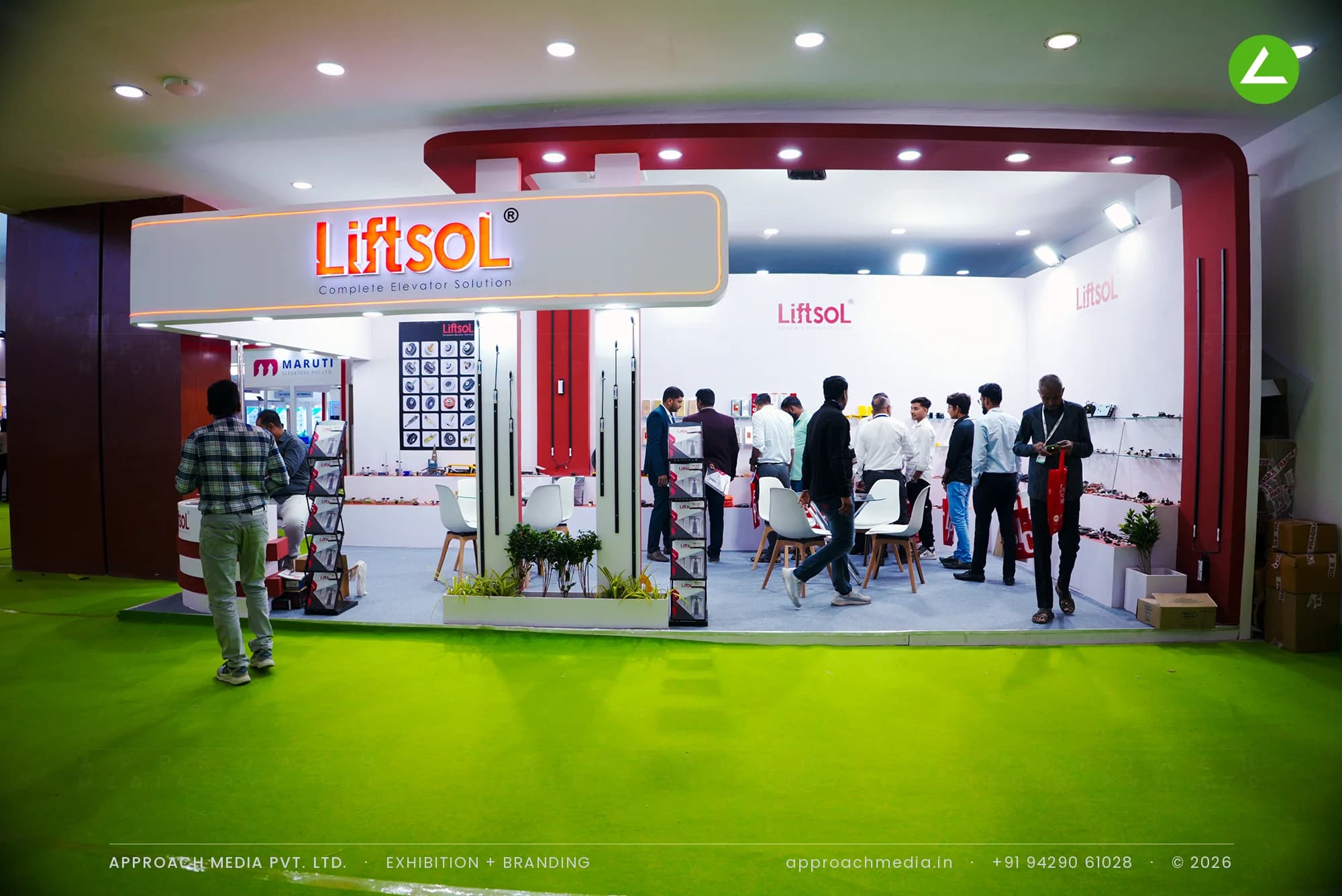LiftsoL exhibition stall design at Elevator and Escalator Expo Gandhinagar with a lit logo soffit and maroon corner columns