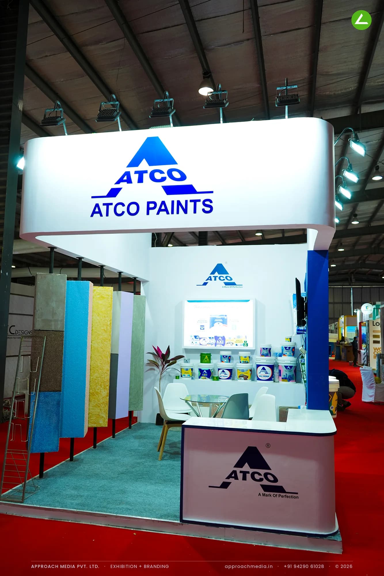 ATCO Paints exhibition stall design at GPBS Gandhinagar with hanging texture sample boards and a curved backlit fascia