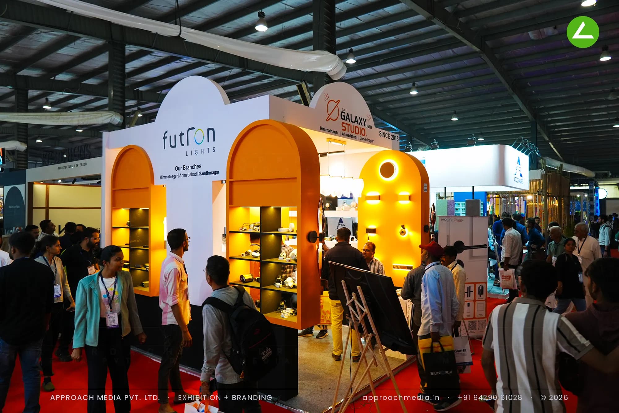 Galaxy Studio and Futron Lights exhibition stall design at GPBS Gandhinagar with orange arched niches and warm lit shelves
