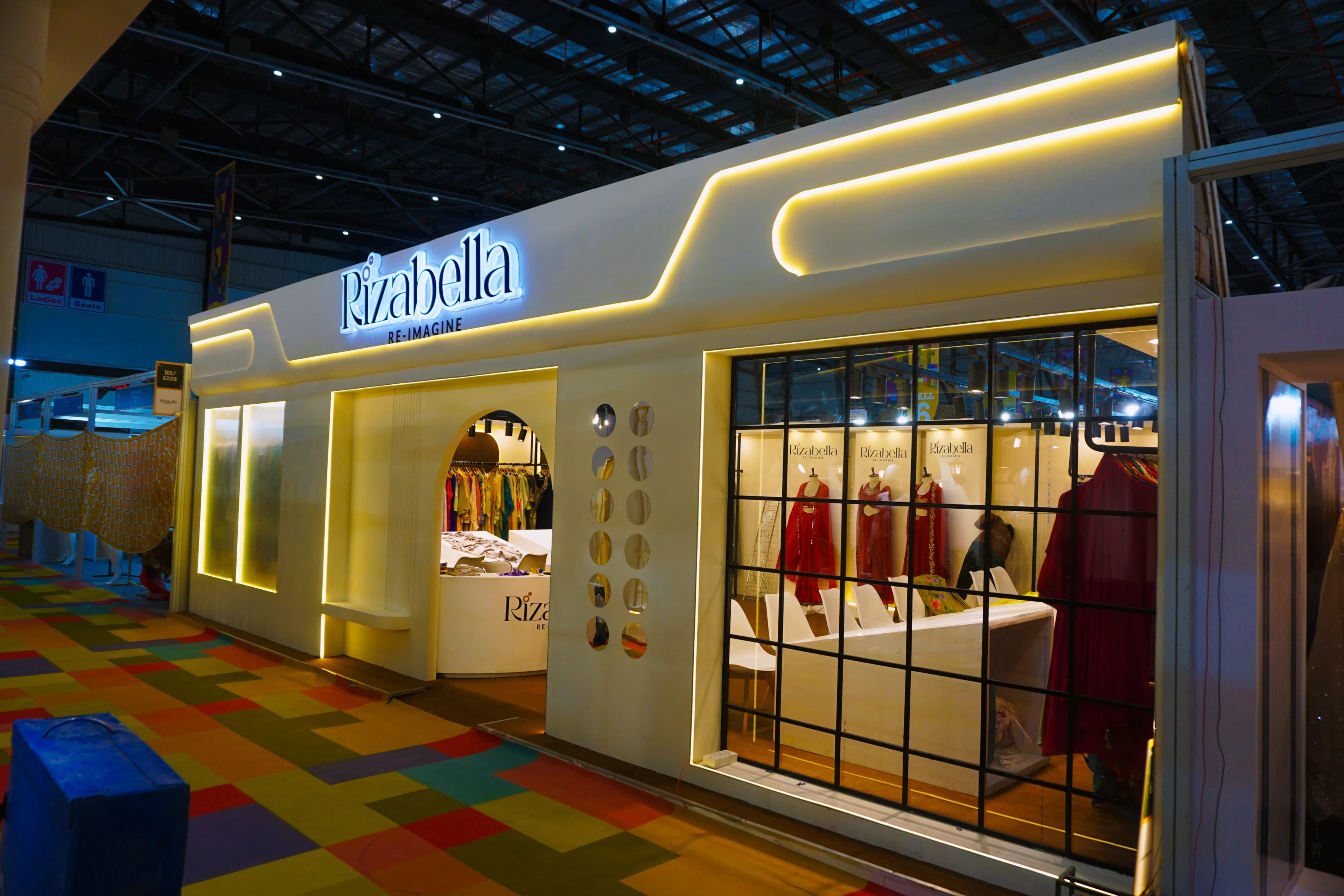 Ivory boutique exhibition stall design at IGTF Expo for Rizabella with arched entry and lit shopfront window