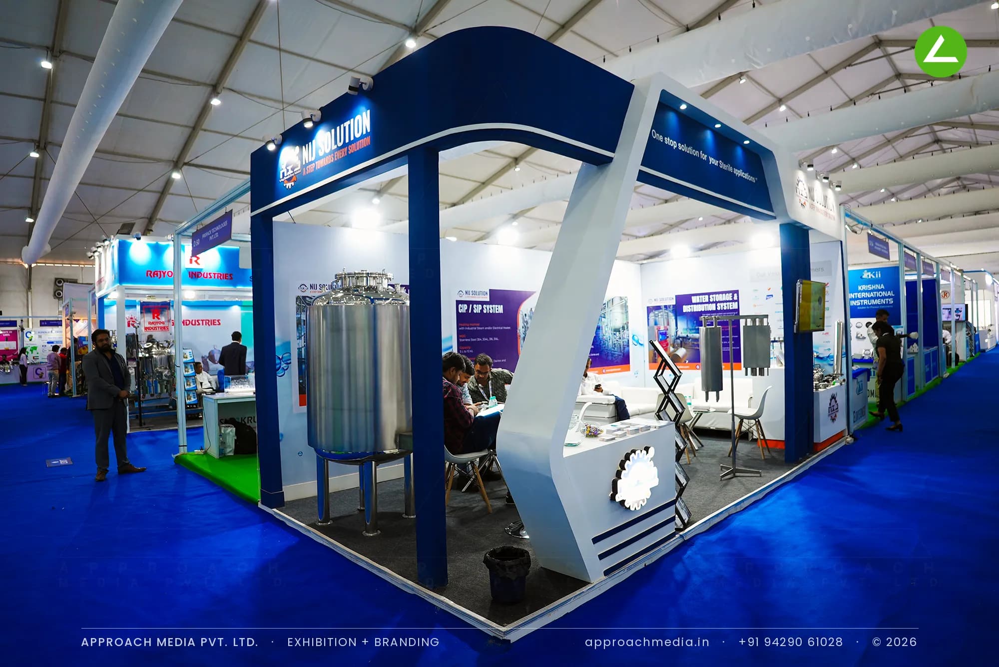 NIJ Solution exhibition stall design at Pharmatech Expo Chandigarh with angular navy portal and steel vessel