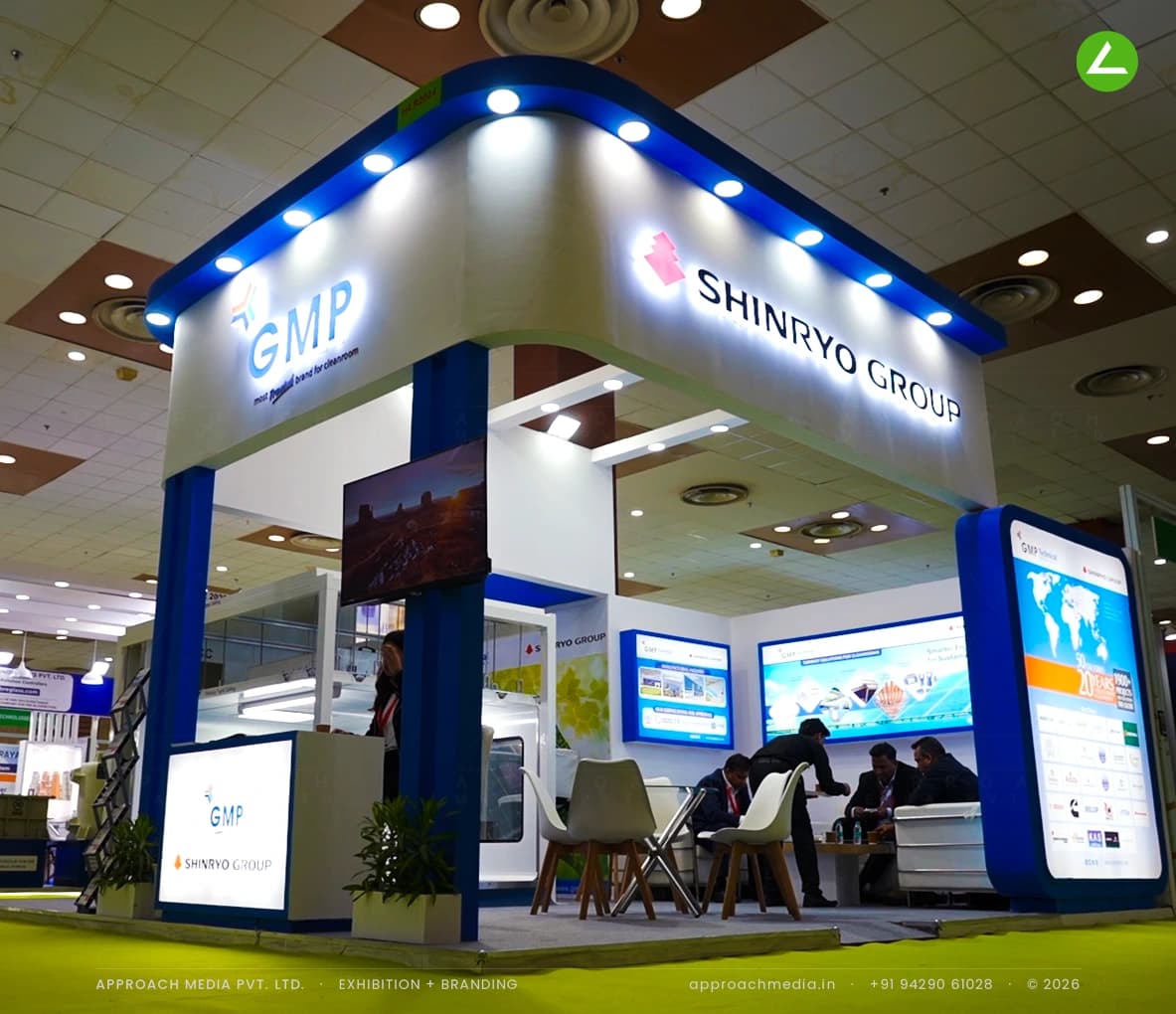 Shinryo Group exhibition stall design at REI Expo Greater Noida with a lit chevron canopy over a cleanroom module