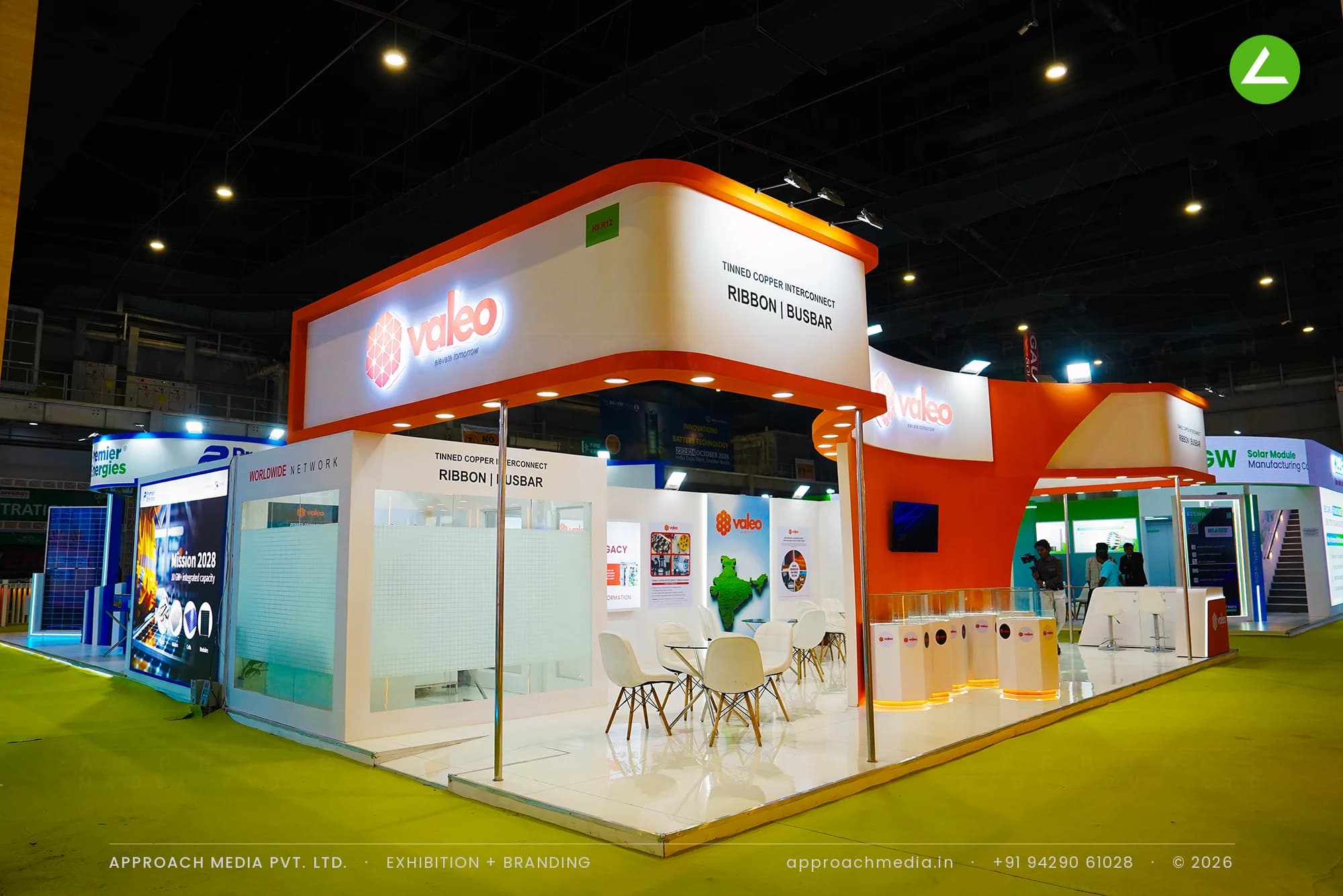 Valeo exhibition stall design at REI Expo Greater Noida with an orange arch wall and lit hexagonal product plinths
