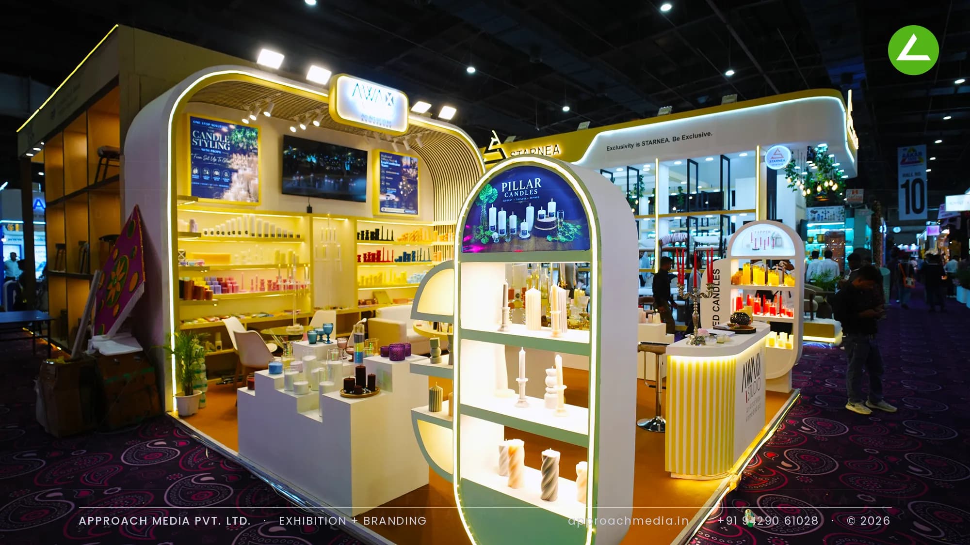 Yellow fluted arch and lit candle shelving — exhibition stall design at Aakar Expo Greater Noida for Awax Studio