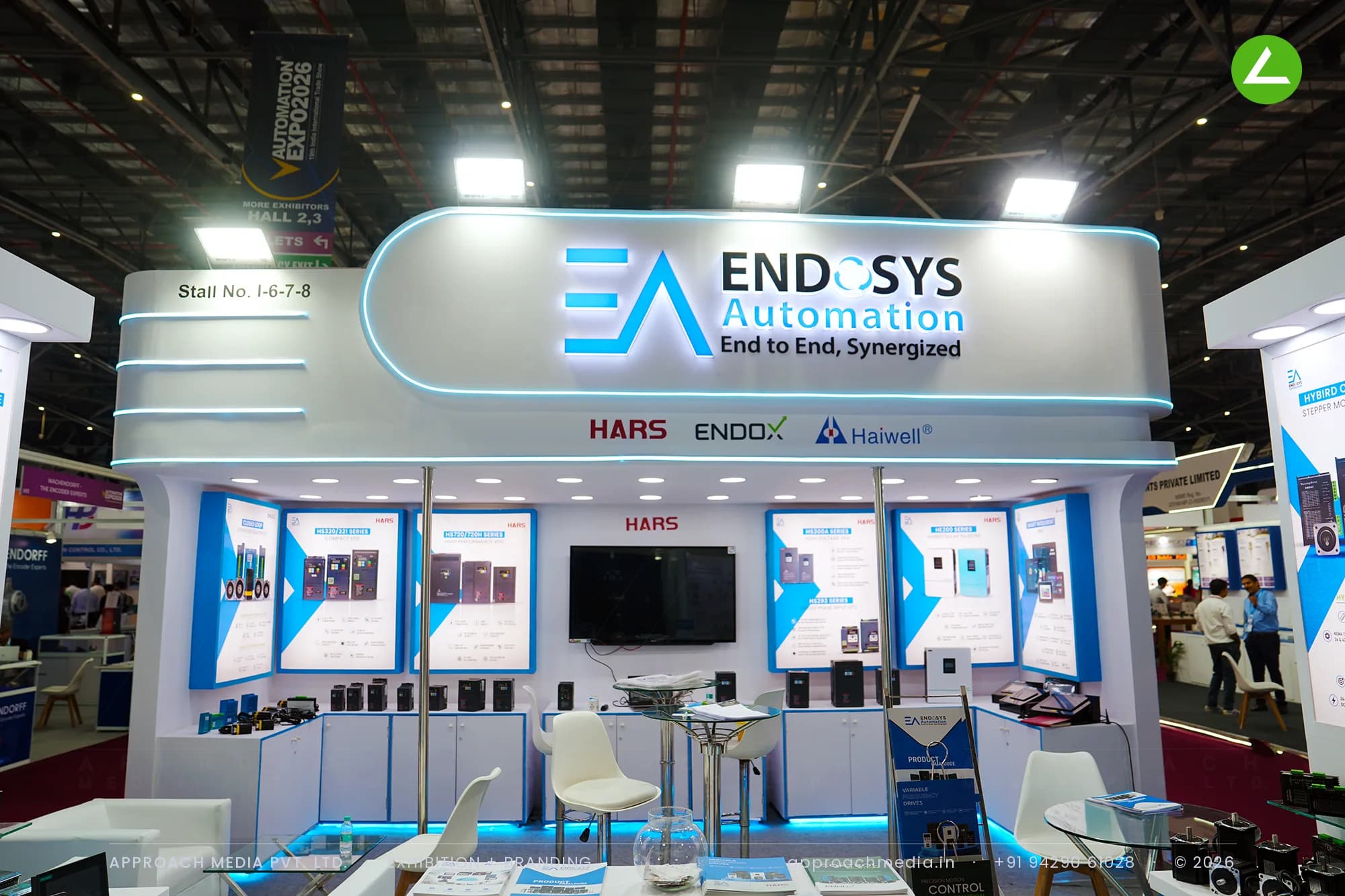 Endosys curved white fascia over a backlit product wall — exhibition stall design at Automation Expo Mumbai