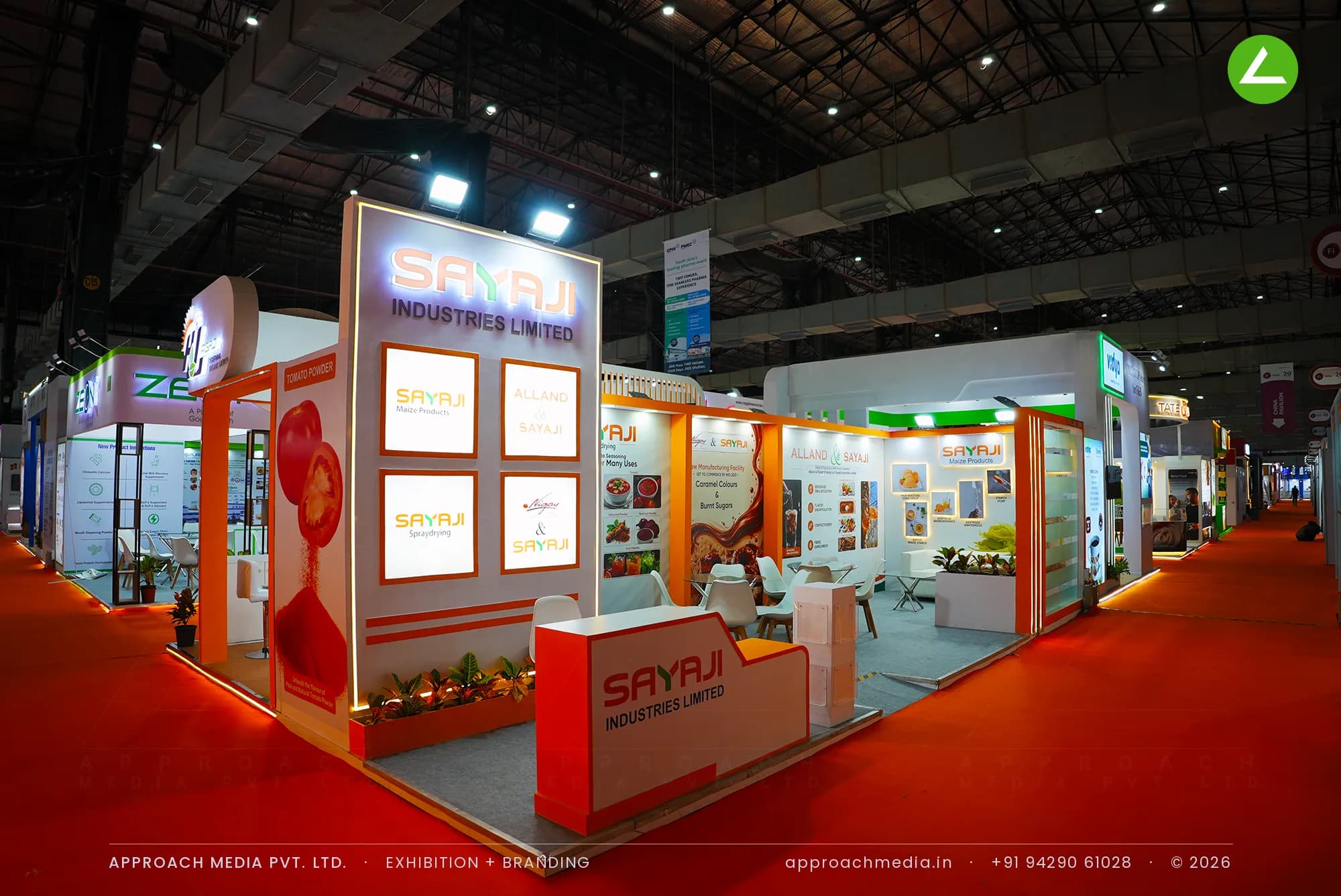 Backlit logo portal and four brand lightboxes in the exhibition stall design at Fi India Mumbai for Sayaji Industries