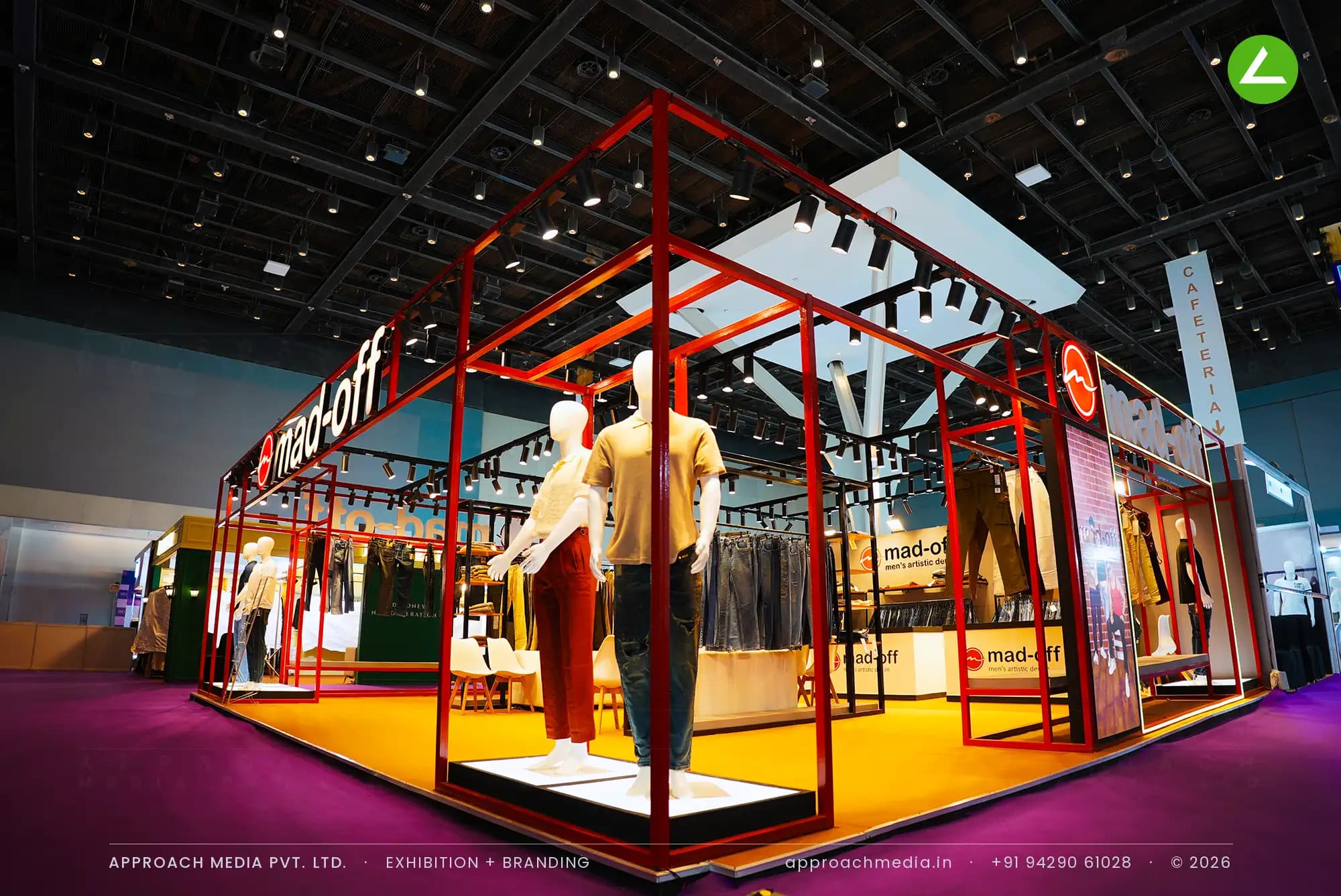 Open red steel frame over denim rails and mannequins — exhibition stall design at IGTF Man Expo Mumbai for Madoff