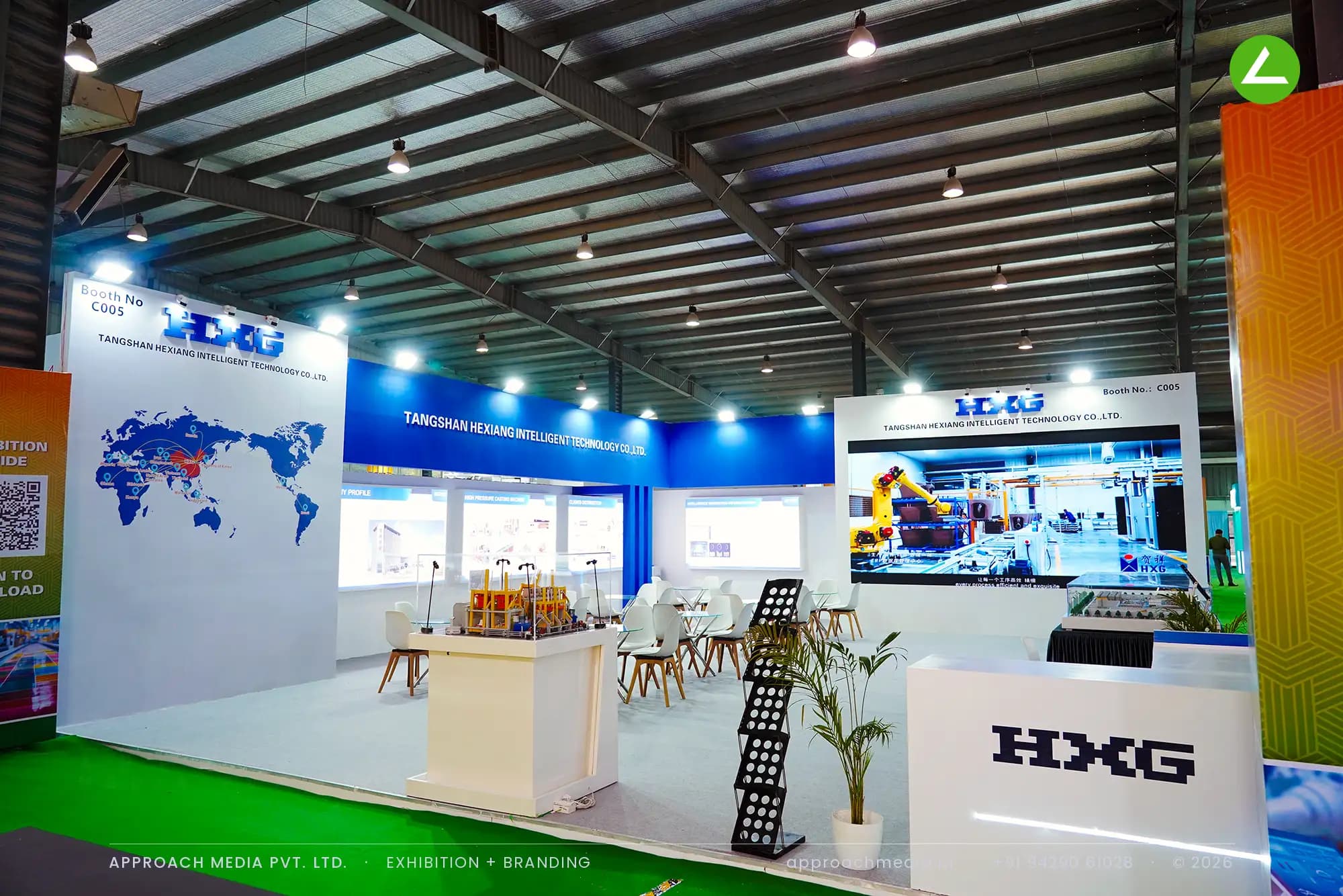 HXG exhibition stall design at Indian Ceramics Asia Gandhinagar with blue fascia band, LED wall and machine scale models