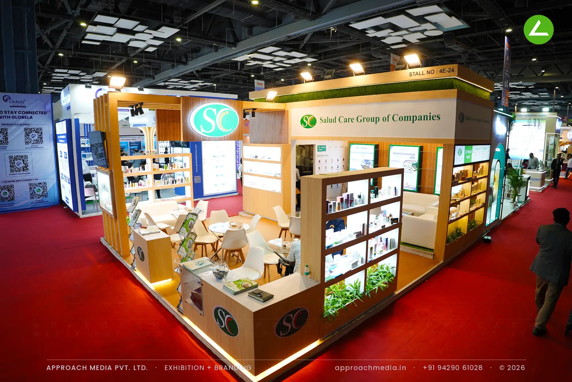 Salud Care's timber slat stand with turf-topped fascia, an exhibition stall design at IPHEX New Delhi