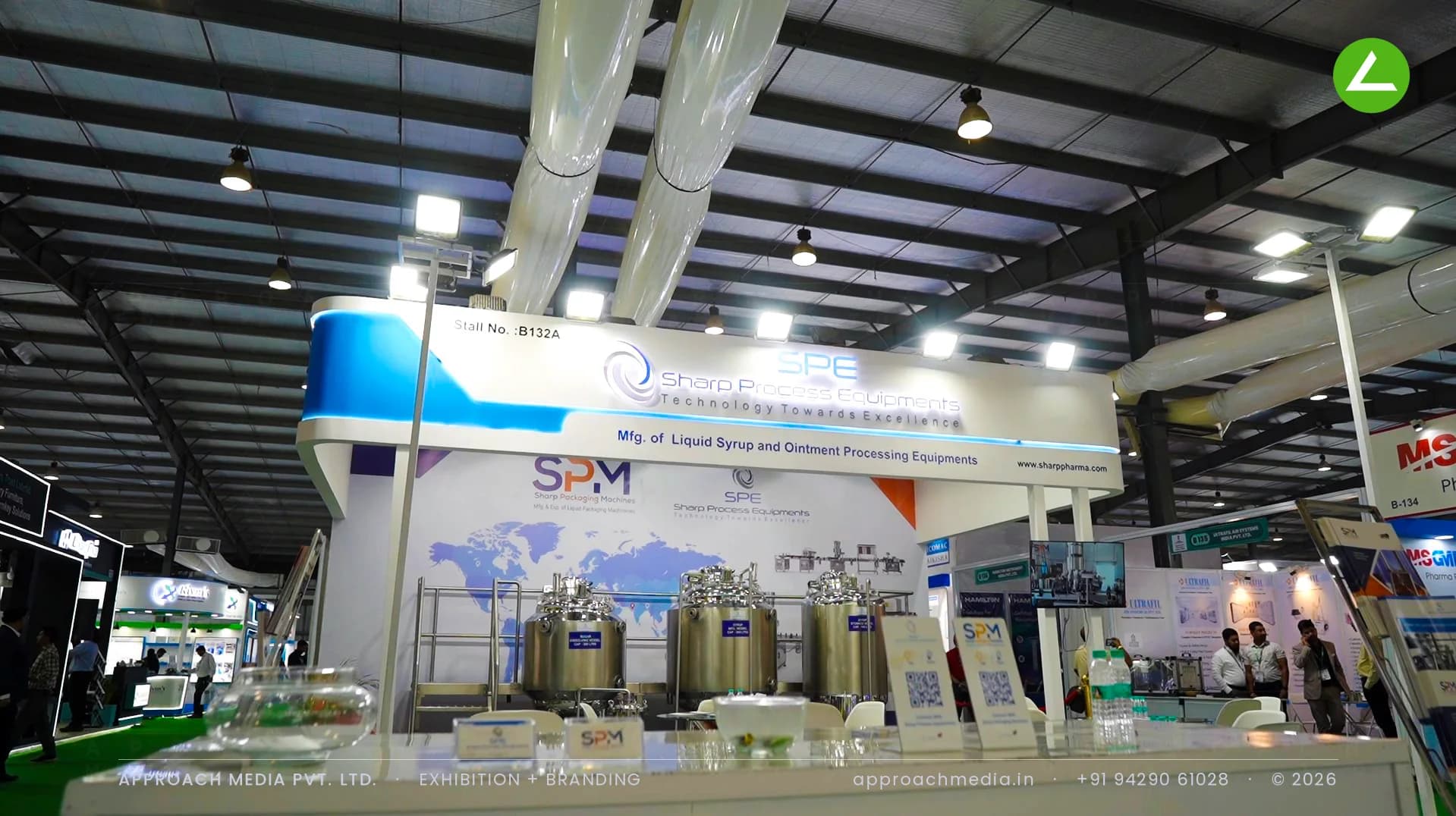 Sharp Process Equipments stall design at Pharmatech Expo Gandhinagar with a lit canopy over stainless processing vessels
