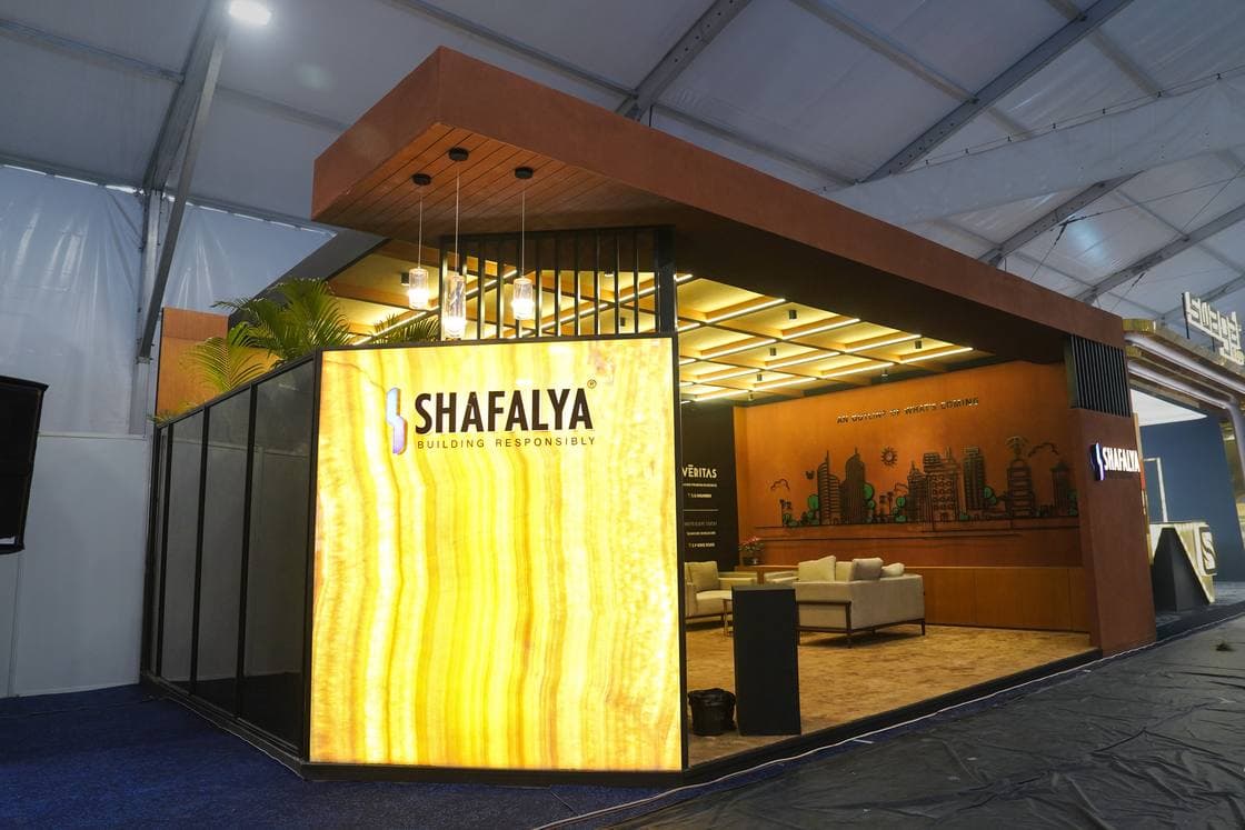 Warm-lit custom real estate exhibition booth at a 72 sqm property expo